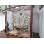 A cased model of a galleon with plaque dated 1938.