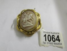 A large vintage shell cameo depicting St, George slaying the dragon in yellow metal mount.