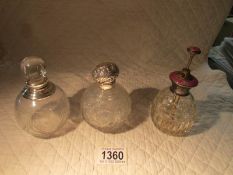 3 silver topped scent bottles.