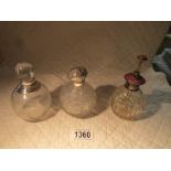 3 silver topped scent bottles.