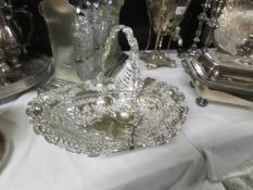 An ornate silver plate basket and a ladle.