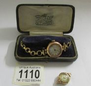 A 9ct gold ladies watch on yellow metal bracelet and a 9ct gold watch head.