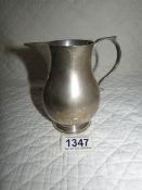 A silver milk jug Hall Marked Birch & Gaydon Ltd., London 1935/36 with Jubilee mark.