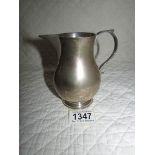 A silver milk jug Hall Marked Birch & Gaydon Ltd., London 1935/36 with Jubilee mark.