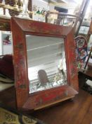 A Chinese style framed mirror.