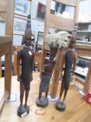 3 carved tribal figures.