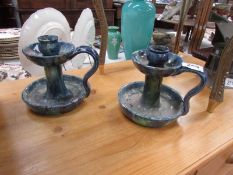 A pair of studio pottery candlesticks.
