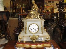 An onyx and gilt mantel clock surmounted Greek style lady.