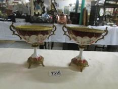 A pair of continental porcelain and ormolu urns, 1 a/f.