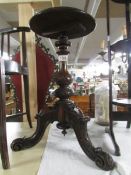A good quality mahogany tripod table with carved base.