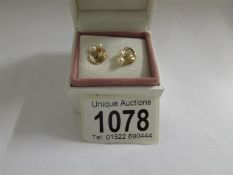 A pair of pretty textured gold cultured pearl set earrings in 9ct gold, circa 1970's.