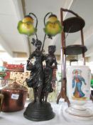 A figural 2 light table lamp with glass shades.