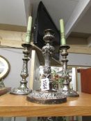 A pair of silver plate candlesticks and one other.
