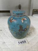 A signed Chinese ginger jar decorated with butterflies and flowers.