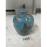 A signed Chinese ginger jar decorated with butterflies and flowers.