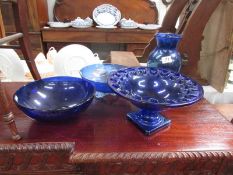 3 blue glass bowls and a blue glass vase.