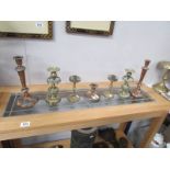 2 pairs of brass candlesticks, a pair of copper candlesticks and a brass chamber stick.