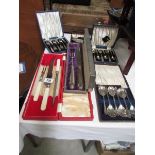 A quantity of cased cutlery sets.