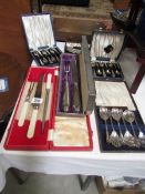 A quantity of cased cutlery sets.