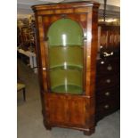 A mahogany open front corner cabinet.