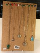 Five pendants on chains.