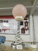 An art deco chrome barley twist lamp with pink shade.