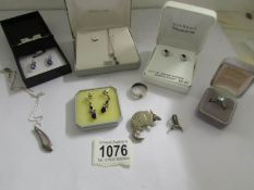 3 pairs of silver earrings, 2 silver pendants, a silver ring,