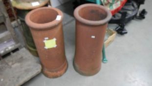 A pair of terracotta chimney pots.