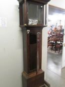 An oak long cased clock case complete with weights.