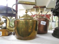 A Victorian copper kettle and a brass kettle.
