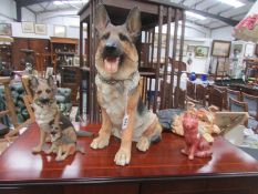 A large German Shepherd dog and other dogs.