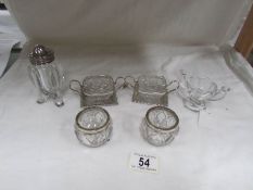 A pair of Walker & Hall salts and other condiment items.