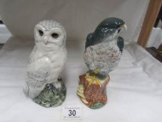 A Whyte and Mackay Snowy Owl decanter with contents together with an eagle decanter and contents.