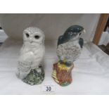 A Whyte and Mackay Snowy Owl decanter with contents together with an eagle decanter and contents.
