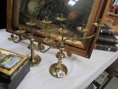 A pair of arts and crafts style graduated brass candlesticks.