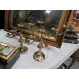 A pair of arts and crafts style graduated brass candlesticks.