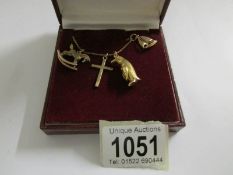 A 9ct gold cross, penguin, rocking horse and yacht on gold chain, 9 grams.