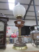 A brass oil lamp complete with shade and chimney.