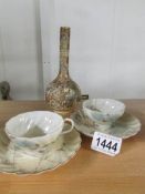 A Satsuma 'bottle' vase and a pair of porcelain cups and saucers.