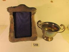 A silver photo frame and a silver sugar bowl,.