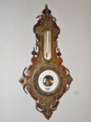 A barometer with embossed metal print.