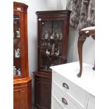 A mahogany corner cabinet.