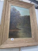 A gilt framed oil painting of a river scene signed Adams.