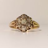 An 18ct gold ring set with 7 diamonds in a flower head design, size M.