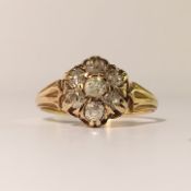 An 18ct gold ring set with 7 diamonds in a flower head design, size M.