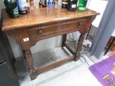 A good quality single drawer oak side table.