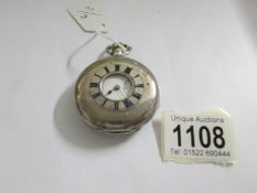 A silver half hunter pocket watch, in working order. (face marked J.W.