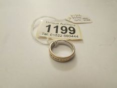 An 18ct gold band ring set seven diamonds, approximately 5.6 grams, size J.