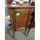 A mahogany inlaid pot cupboard.