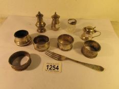 4 silver napkin rings and 7 other items of silver,.